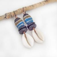 These handmade earrings feature colorful blue, cocoa brown and black painted wood beads accented with cowrie shell dangles and black jasper beads. They have a bold, ethnic tribal flair and will make a unique statement.