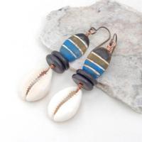 These handmade earrings feature colorful blue, cocoa brown and black painted wood beads accented with cowrie shell dangles and black jasper beads. They have a bold, ethnic tribal flair and will make a unique statement.