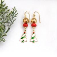 Full of whimsical holiday charm, these handmade dangle earrings feature small 14K gold plated Christmas tree charms with a colorful enameled finish. They are accented with red coral and textured gold brass beads. Perfect for the holiday and Christmas season, they'll make a great gift for women of all ages. Earrings are lightweight and comfortable to wear. 