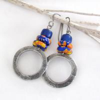 These handcrafted earrings feature silver pewter circle hoops with a hand stamped texture accented with colorful African glass beads and navy blue glass beads. They have an earthy, boho style and are lightweight and comfortable to wear.  MEASUREMENTS: Total length 2" from top of gray silver niobium (hypoallergenic) ear wires and 1” at widest point. The circles were created out of solid lead-free pewter; hand stamped and oxidized; and signed on the back with my initials