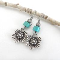 These handcrafted earrings feature silver tone pewter flowers accented with turquoise stones and round textured silver beads. The flowers have a beautiful 3-dimensional design with lots of great intricate detail. They'll make a great gift for a gardener, nature or flower lover.