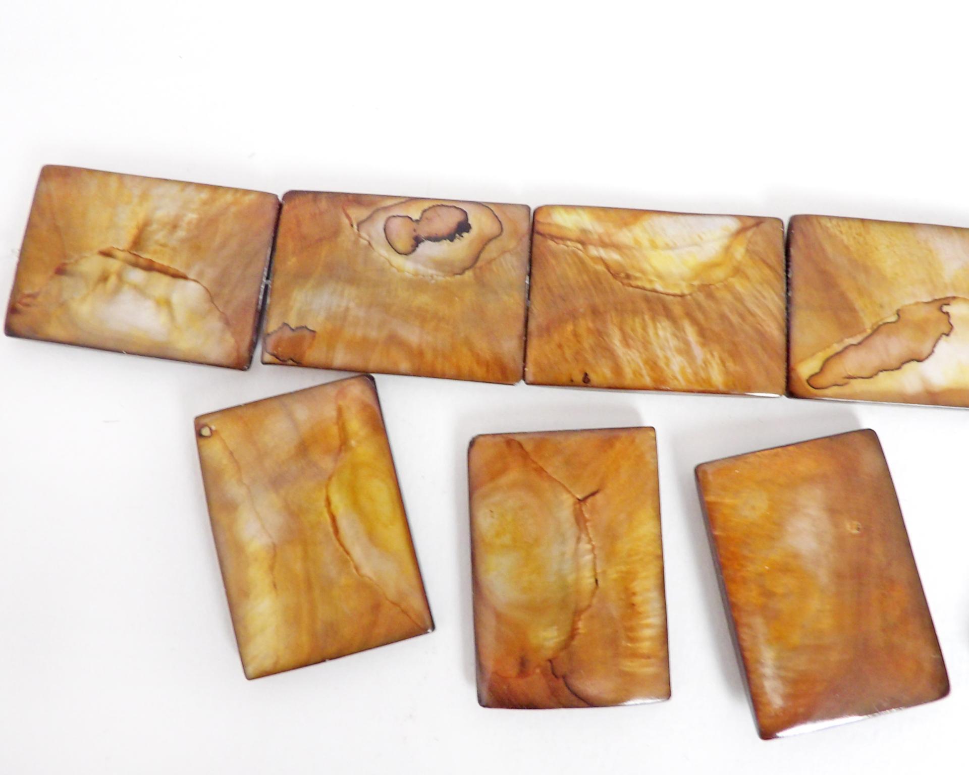 Beautiful Golden Mother of Pearl beads for jewelry making. Nice large rectangular size for pendants measuring approx. 1-3/8" in length and 1" width. Drilled top to bottom. Total of 10 pieces. 