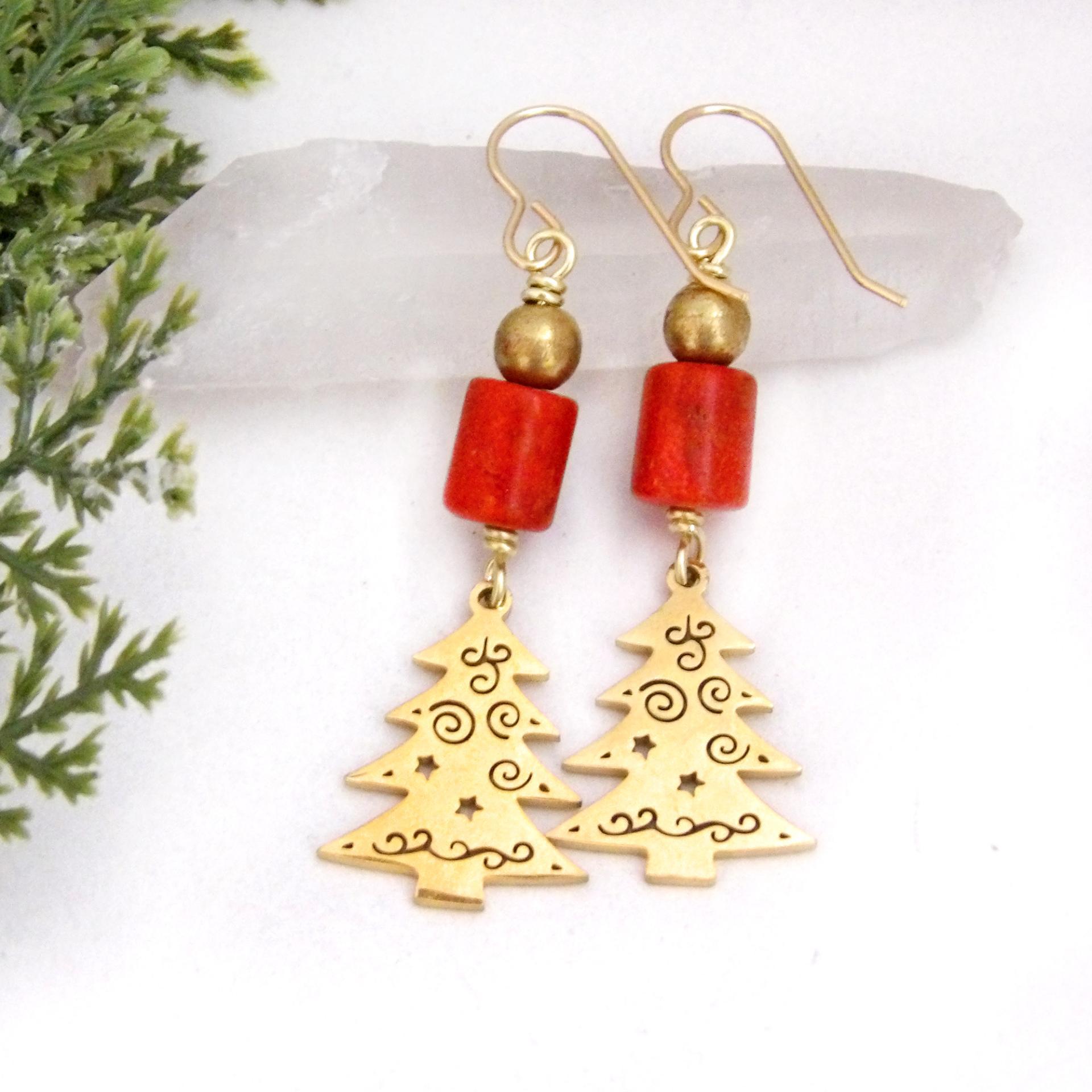 These handmade earrings feature 18K gold plated Christmas tree charms with a whimsical cut-out pattern of spirals and swirls. They are accented with red coral and gold brass beads. Full of holiday charm, they'll make a great Christmas / holiday gift for women of all ages. Earrings are lightweight and comfortable to wear. 