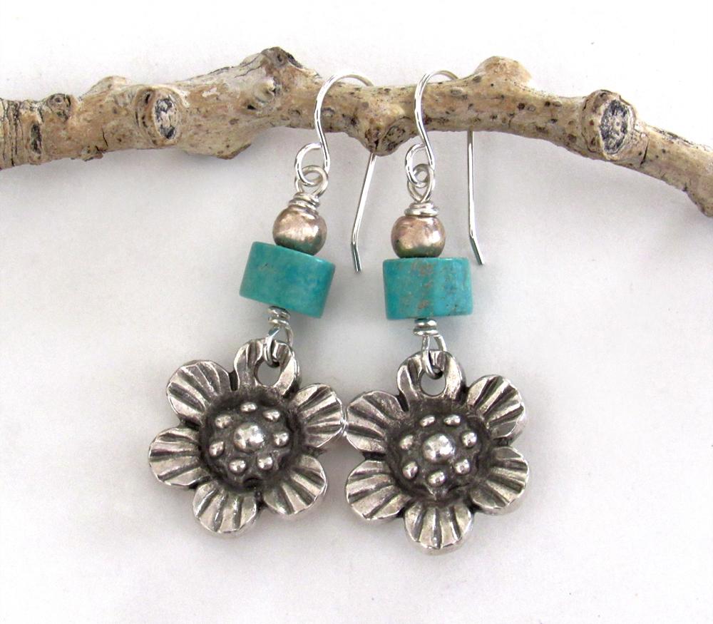 These handcrafted earrings feature silver tone pewter flowers accented with turquoise stones and round pewter beads. The flowers have a beautiful 3-dimensional design with lots of great detail. They'll make a great gift for a gardener, nature or flower lover.
